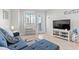 Inviting living room featuring a comfortable blue sofa, games, and access to a private balcony at 2001 S Ocean Blvd. # 720, Myrtle Beach, SC 29577