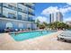 Outdoor pool area with ample lounge chairs, clear water, and beautiful landscaping at 2001 S Ocean Blvd. # 720, Myrtle Beach, SC 29577