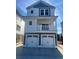Charming two-story home with a balcony and a two-car garage featuring white doors at 201-E Madison Ct., Myrtle Beach, SC 29577