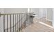 Second story hallway with decorative railings leading to bedrooms and a well-lit office nook at 201-E Madison Ct., Myrtle Beach, SC 29577