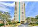 Exterior of a high-rise building with private balconies, set among green trees and blue sky at 210 75Th Ave. N # 4034, Myrtle Beach, SC 29572