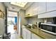 Compact kitchenette with essential appliances and a pass-through to the dining and living area at 210 75Th Ave. N # 4034, Myrtle Beach, SC 29572