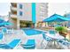 Outdoor pool with patio furniture, lounge chairs, and umbrellas for relaxation at 210 75Th Ave. N # 4034, Myrtle Beach, SC 29572