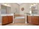 Bathroom featuring double vanities and a tiled corner bathtub at 213 76Th Ave. N, Myrtle Beach, SC 29577