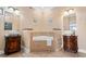 Spacious bathroom with dual vanities and a centered soaking tub with tile surround at 213 76Th Ave. N, Myrtle Beach, SC 29577