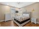 Cozy bedroom featuring a queen sized bed, wood floors, ceiling fan, and nautical decor at 213 76Th Ave. N, Myrtle Beach, SC 29577
