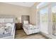 A bedroom with two beds, an outdoor patio, and light-colored walls at 213 76Th Ave. N, Myrtle Beach, SC 29577