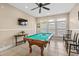 This game room features a pool table, a TV, and tile floors at 213 76Th Ave. N, Myrtle Beach, SC 29577