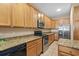 A kitchen featuring stainless appliances, granite countertops, and wood cabinets at 213 76Th Ave. N, Myrtle Beach, SC 29577