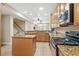 The kitchen features stainless appliances, tile floors, and wooden cabinetry at 213 76Th Ave. N, Myrtle Beach, SC 29577