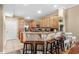 Kitchen with breakfast bar seating, light wood cabinetry, granite countertops, and stainless steel appliances at 213 76Th Ave. N, Myrtle Beach, SC 29577