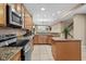 Well-lit kitchen features stainless steel appliances, granite countertops, and tiled floors at 213 76Th Ave. N, Myrtle Beach, SC 29577