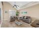 Bright living room featuring two sofas, tile floors, ceiling fan, and access to a patio with natural light at 213 76Th Ave. N, Myrtle Beach, SC 29577