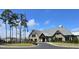 Beautiful gray and stone clubhouse with a flag pole and an inviting entrance at 216 Kinross Ct., Little River, SC 29566