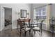 Well-lit dining room featuring a glass table set, wood floors, and classic decor accents at 216 Kinross Ct., Little River, SC 29566