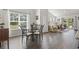 Dining room with natural light, hardwood floors, and an open layout to a cozy living space at 216 Kinross Ct., Little River, SC 29566