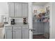 Kitchen space with granite countertops, gray cabinets, and a door opening to a pantry at 216 Kinross Ct., Little River, SC 29566