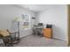 Bright home office with a window view, wood desk, and a comfortable rocking chair, ideal for remote work at 216 Kinross Ct., Little River, SC 29566