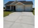 Charming home with a two-car garage, well-manicured lawn, and a concrete driveway, ready for its new owners at 2247 Society Dr., Conway, SC 29527