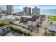Bright aerial view of a coastal complex near the beach, with colorful buildings, mature trees, and ample parking at 2710 S Ocean Blvd. # 407-A, Myrtle Beach, SC 29577