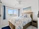 Bright bedroom with a large window, blue accents, and a decorative bed at 2710 S Ocean Blvd. # 407-A, Myrtle Beach, SC 29577