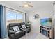 Comfortable living room featuring a plush leather sofa, flat screen TV, and plenty of natural light at 2710 S Ocean Blvd. # 407-A, Myrtle Beach, SC 29577