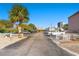 Outdoor parking lot view featuring ample parking spots, lush palm trees, and a glimpse of nearby vacation rentals at 2710 S Ocean Blvd. # 407-A, Myrtle Beach, SC 29577