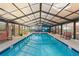 Clear blue indoor pool is surrounded by seating areas at 2710 S Ocean Blvd. # 407-A, Myrtle Beach, SC 29577