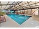 Indoor pool area with clear blue water, surrounded by seating and plants at 2710 S Ocean Blvd. # 407-A, Myrtle Beach, SC 29577