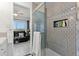 Modern shower featuring sleek subway tile, glass door, and built-in shelving for toiletries and towel rack at 2710 S Ocean Blvd. # 407-A, Myrtle Beach, SC 29577