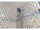 Chrome shower head with a handheld attachment is set against a tiled wall at 2710 S Ocean Blvd. # 407-A, Myrtle Beach, SC 29577