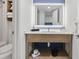 Bright bathroom featuring a modern vanity, a mirrored wall, and a tile backsplash at 3000 N Ocean Blvd. # 130, Myrtle Beach, SC 29577
