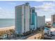 Breathtaking oceanfront resort showcasing multiple floors with private balconies and stunning beach views at 3000 N Ocean Blvd. # 130, Myrtle Beach, SC 29577