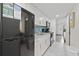 The kitchenette includes white cabinets, sleek countertops, a refrigerator, and modern appliances at 3000 N Ocean Blvd. # 130, Myrtle Beach, SC 29577