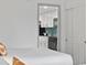 A modern kitchenette featuring white cabinets, a black stove, and a tiled backsplash at 3000 N Ocean Blvd. # 130, Myrtle Beach, SC 29577