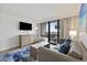 Comfortable living room featuring neutral tones, ocean views, and a flat-screen TV at 3000 N Ocean Blvd. # 130, Myrtle Beach, SC 29577