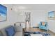Cozy living room featuring comfortable sofa and chair with beach themed paintings at 3000 N Ocean Blvd. # 130, Myrtle Beach, SC 29577
