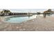 Outdoor pool with a lifeguard sign, deck chairs, and access to amenities at 3000 N Ocean Blvd. # 130, Myrtle Beach, SC 29577