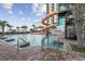 Relaxing pool area featuring a fun water slide and inviting lounge chairs surrounded by palm trees at 3000 N Ocean Blvd. # 130, Myrtle Beach, SC 29577
