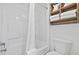 All-white shower and bath area with coordinating towels and shower curtain at 3000 N Ocean Blvd. # 130, Myrtle Beach, SC 29577