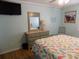 Well-lit bedroom features coastal décor, matching dresser and nightstand, and a mounted television at 305 N Hillside Dr. N # 103, North Myrtle Beach, SC 29582