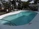 Inviting community pool with lounge chairs and trees at 305 N Hillside Dr. N # 103, North Myrtle Beach, SC 29582