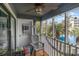 Relaxing screened porch with ceiling fan and view of the pool and palm trees at 305 N Hillside Dr. N # 103, North Myrtle Beach, SC 29582