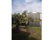 Scenic view from screened window with trees and building at 305 N Hillside Dr. N # 103, North Myrtle Beach, SC 29582