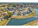 Aerial view showcases the neighborhood's layout, waterfront properties, and community pools at 318 Board Landing Circle, Conway, SC 29526