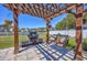 Backyard featuring a cozy fireplace, wood swing, and lush green grass at 318 Board Landing Circle, Conway, SC 29526