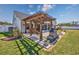 A spacious backyard featuring a pergola, fire pit, and screened porch, perfect for outdoor enjoyment at 318 Board Landing Circle, Conway, SC 29526