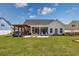 Expansive backyard with covered patio, outdoor kitchen area, and ample seating at 318 Board Landing Circle, Conway, SC 29526