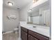 Bright bathroom featuring a white vanity, large mirror, and neutral wall paint at 318 Board Landing Circle, Conway, SC 29526