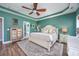 Comfortable bedroom featuring en-suite bathroom access, ceiling fan, and wood-look floors at 318 Board Landing Circle, Conway, SC 29526